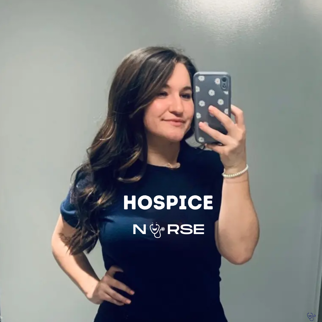 Nurse Em taking selfie in navy blue t-shirt that says Hospice Nurse with stethoscope logo from Nurse cheats